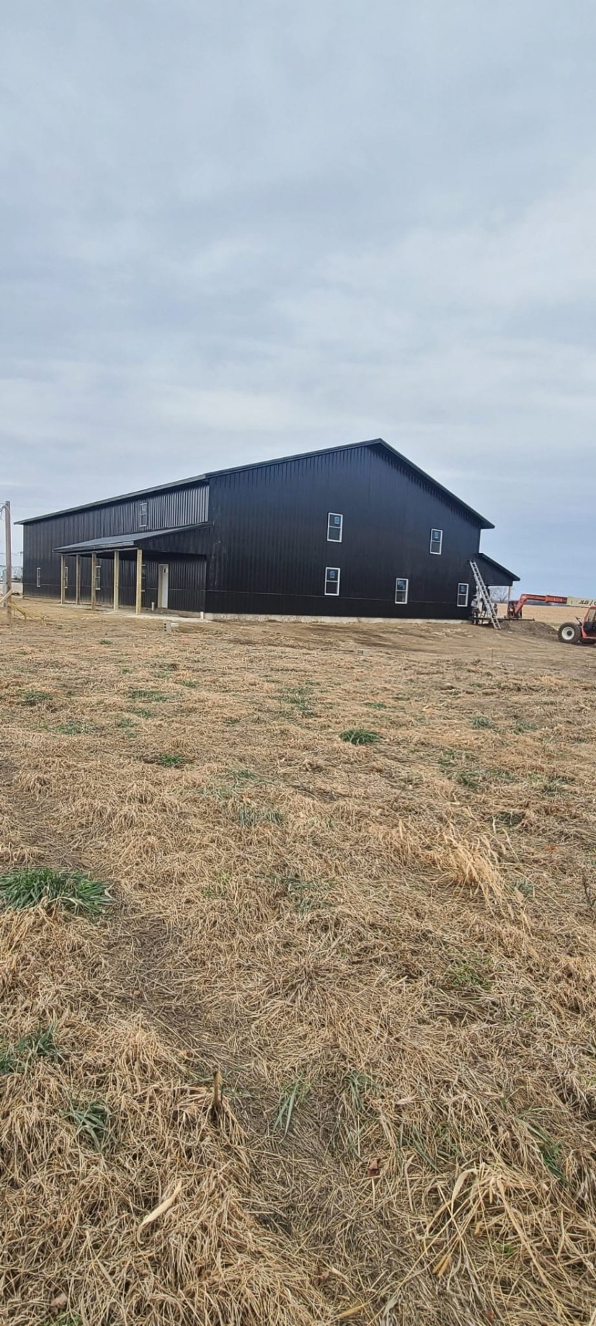 Two-story black metal barndominium build