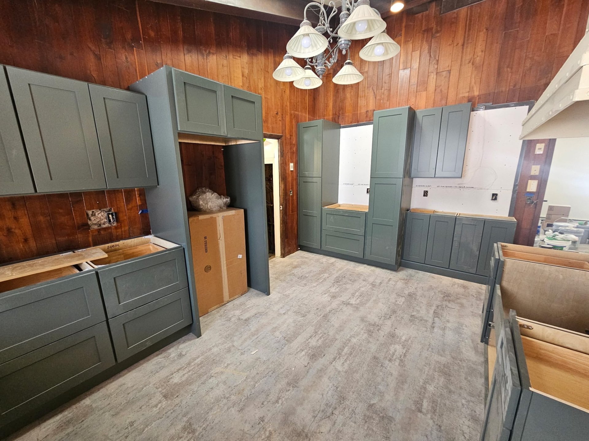 Custom residential kitchen remodel with green cabinetry